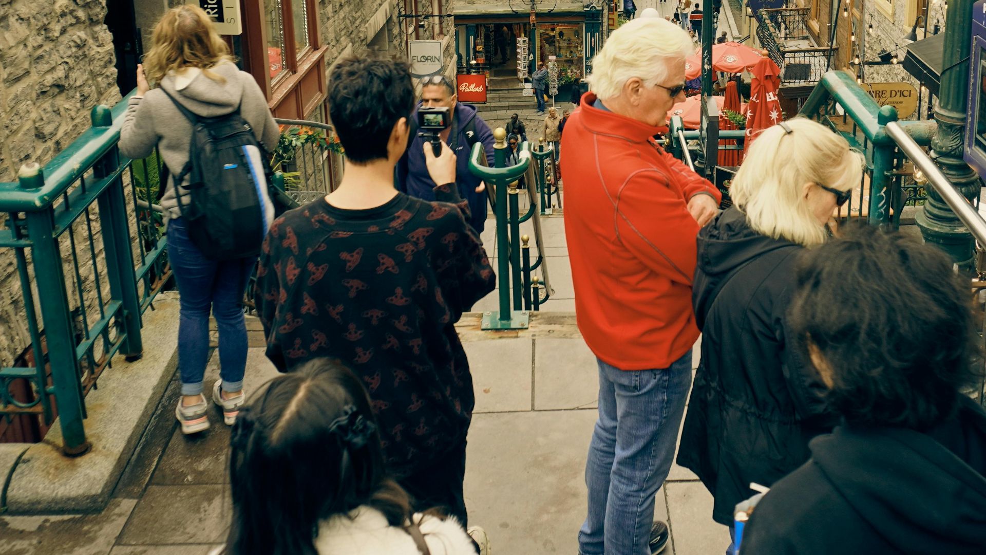 Tourists explore a historic street in Old Quebec, Canada, featuring charming architecture.
