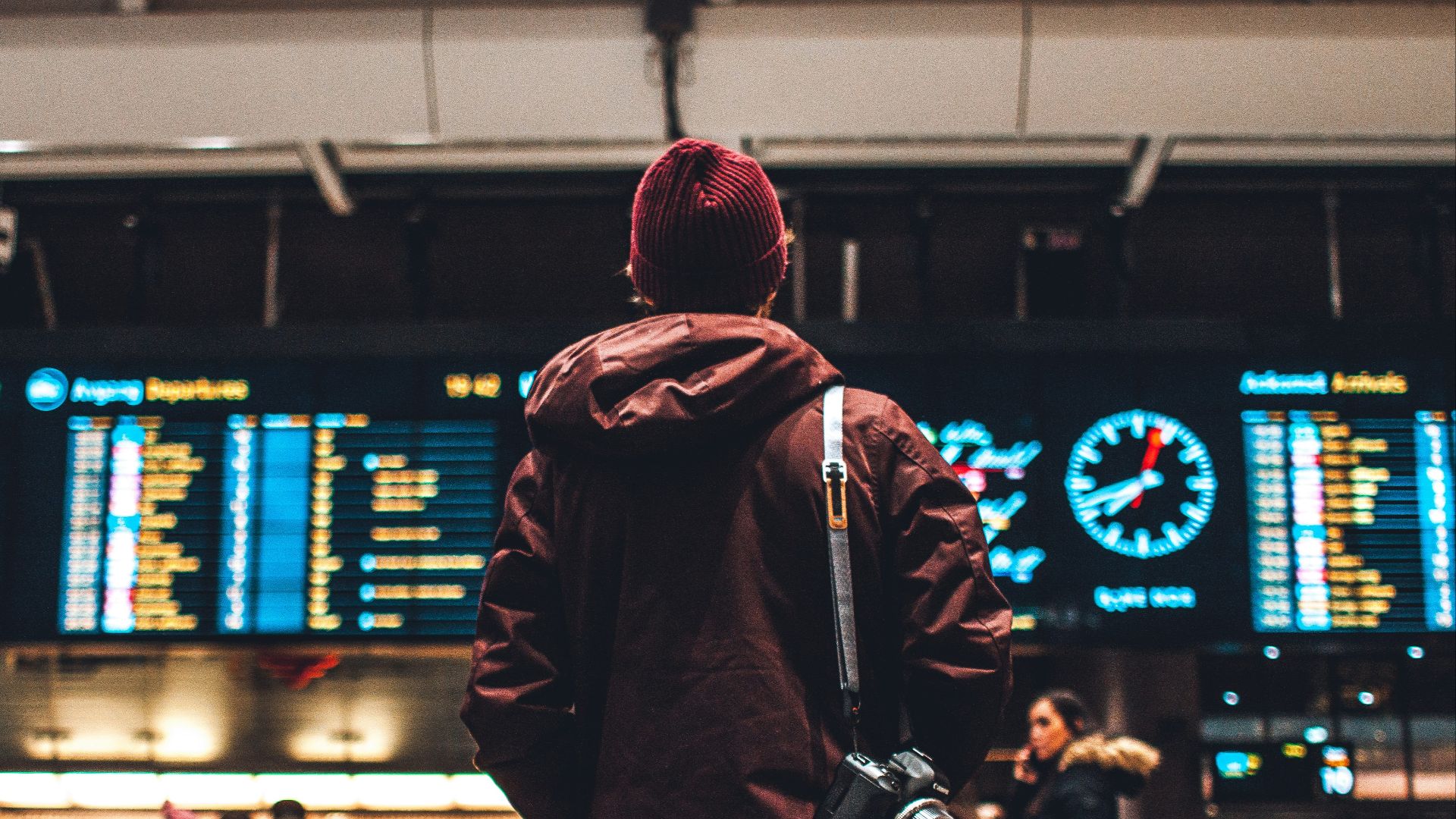 person looking up to the flight schedules