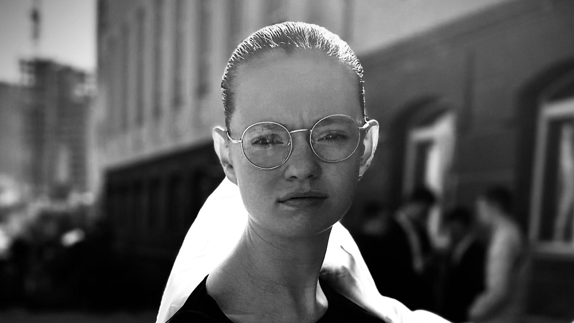 A black and white photo of a woman wearing glasses