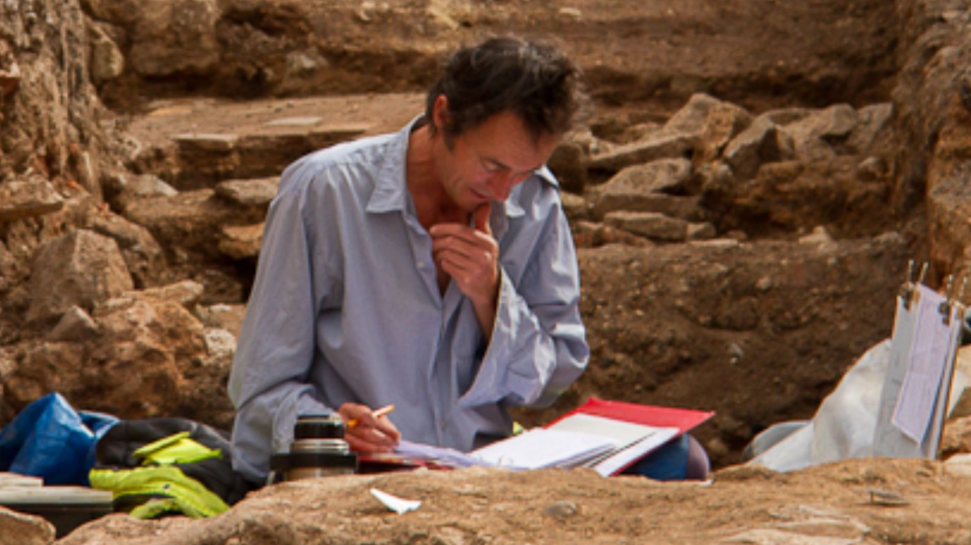 File:Archaeologist working in Trench.jpg