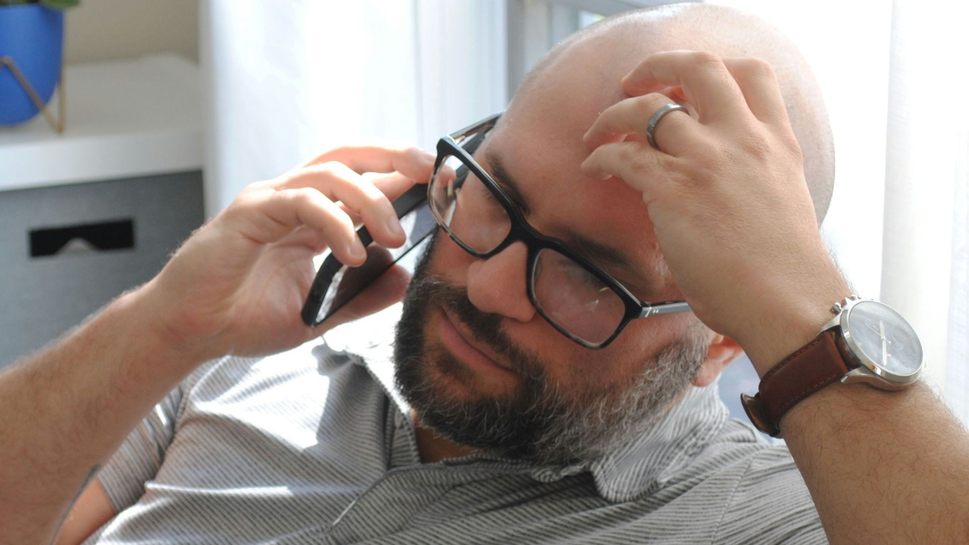 a man with glasses and a watch