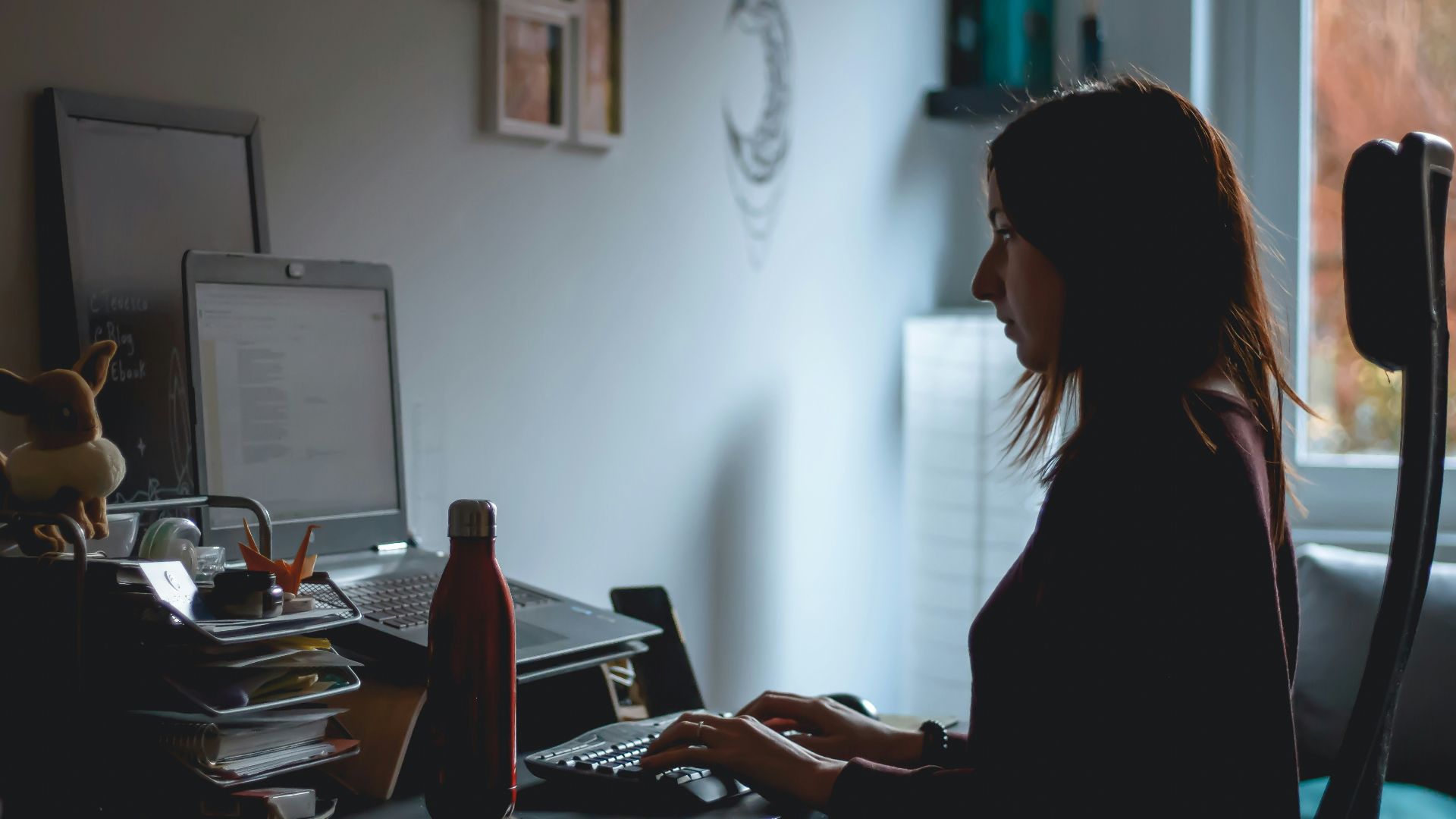 woman in black long sleeve shirt using computer