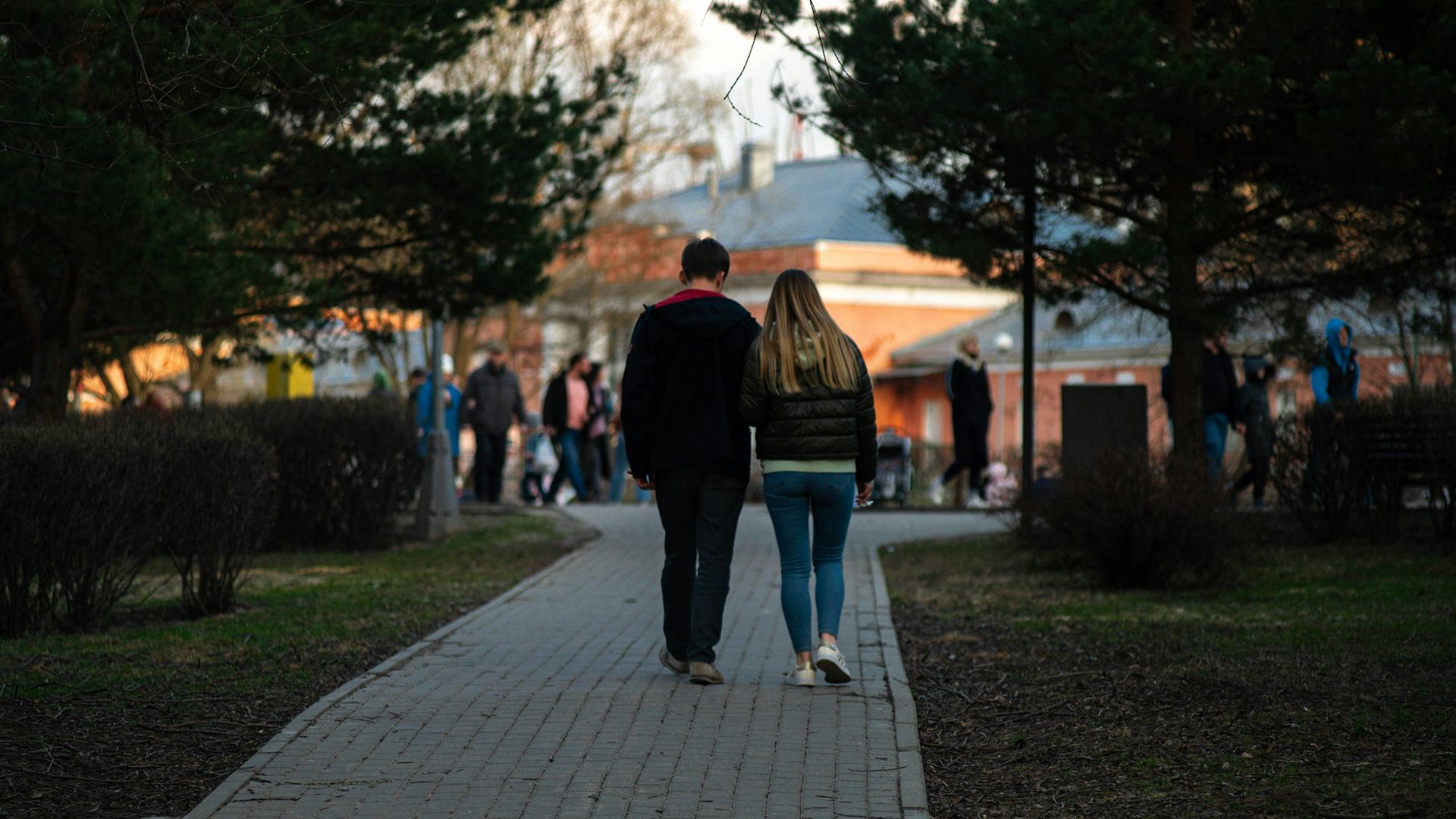 a man and woman walking down a sidewalk