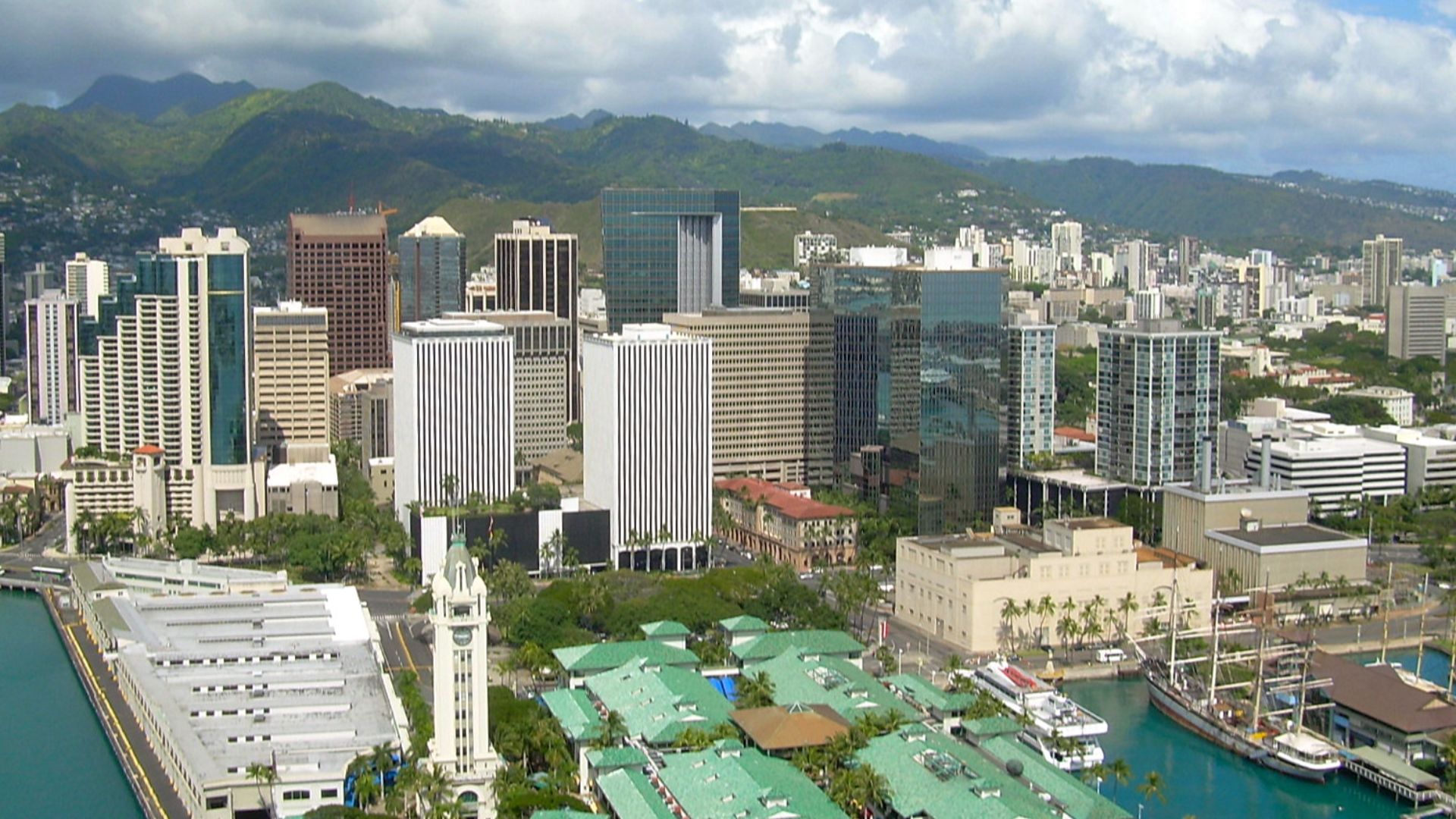 An aerial view of downtown Honolulu, Hawaiʻi taken on April 7, 2007. In the foreground is Aloha Tower, a clock tower and lighthouse greeting visitors to Honolulu Harbor since 1926. In the center of the photo is First Hawaiʻian Center, the tallest building and oldest bank in Hawaiʻi. In the lower right is the Falls of Clyde, the only surviving iron-hulled, four-masted full rigged ship, and the only surviving sail-driven oil tanker in the world. The Falls of Clyde is now a museum ship in Honolulu Harbor.