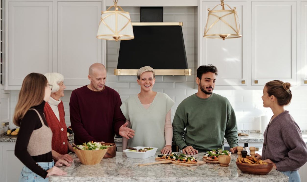 A Family Talking while Standing in the Kitchen