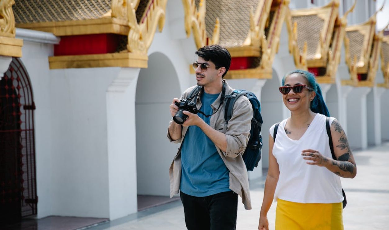 Woman and Man Travelers Walking on City Street