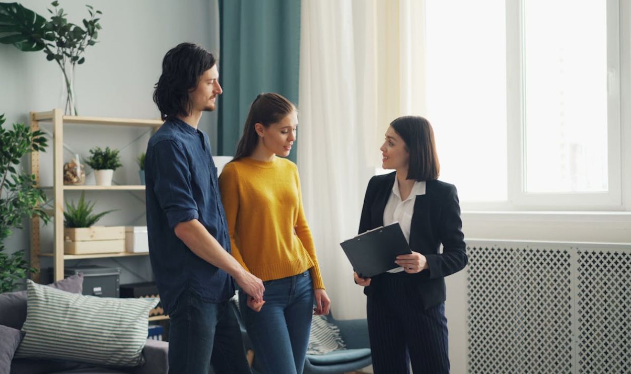 Couple and Real Estate Agent Talking