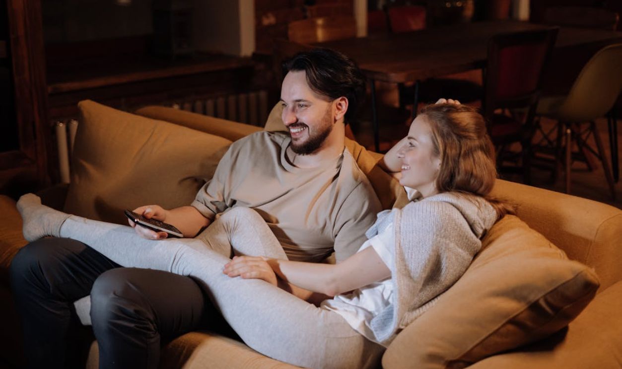 Man and Woman Sitting on Couch