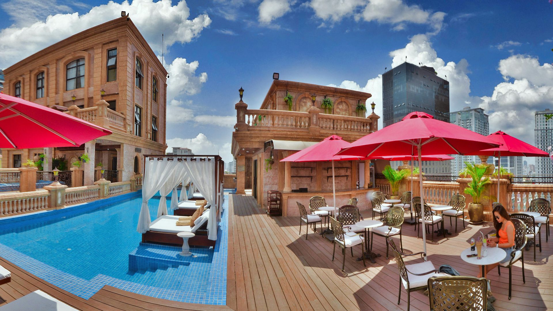 a pool with tables and chairs next to it