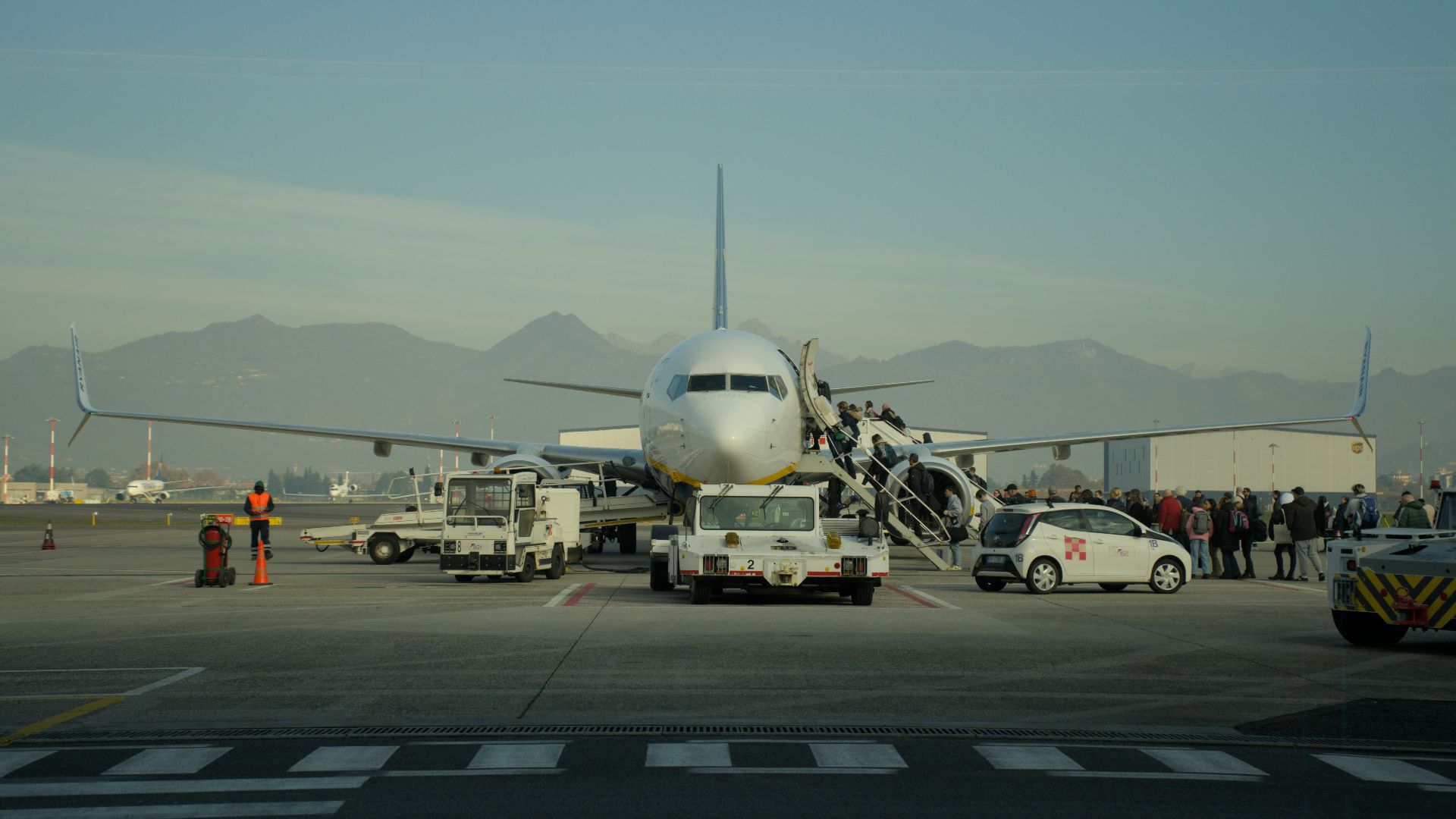 Passengers boarding an airplane at an airport.
