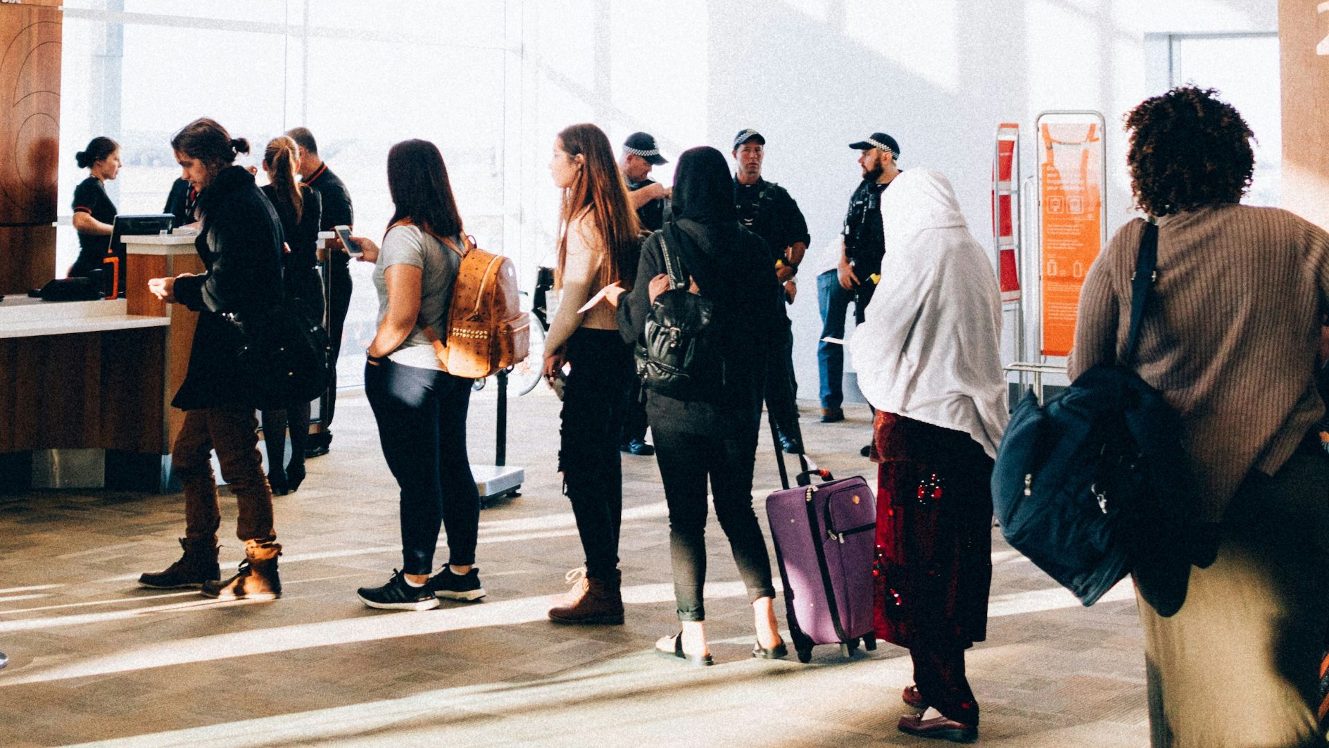 a group of people standing in a large room
