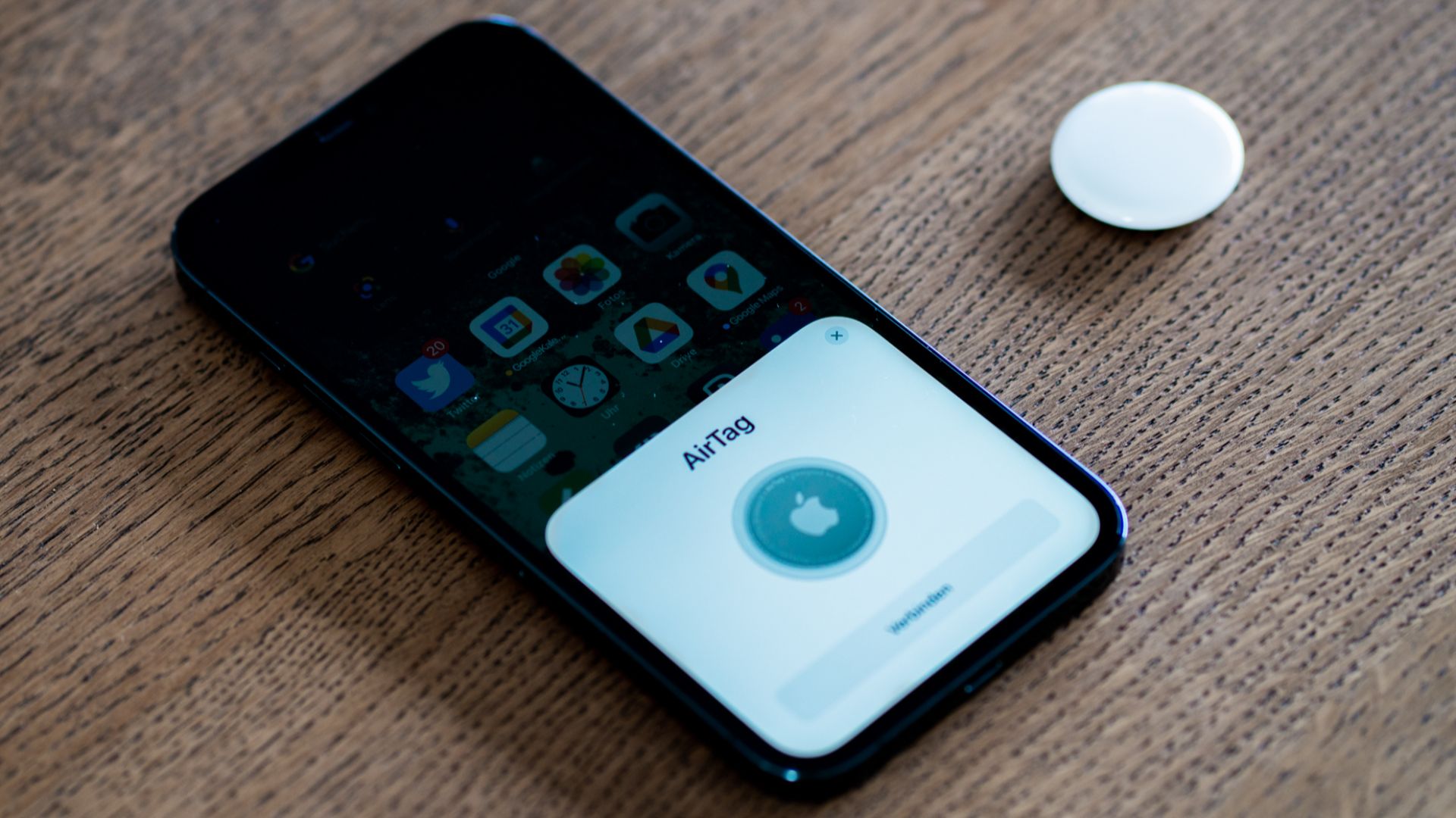 An Apple AirTag being set up using an iPhone 12 Pro Max