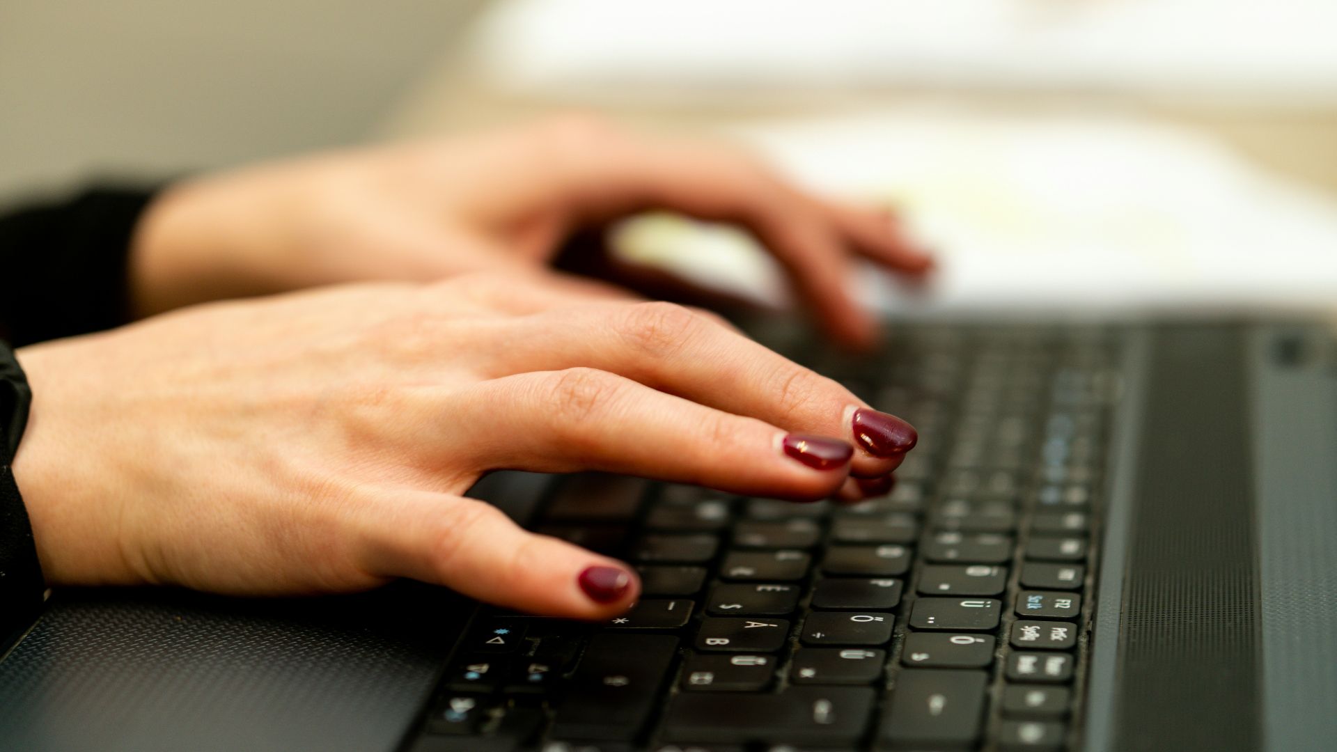 persons hand on black laptop computer