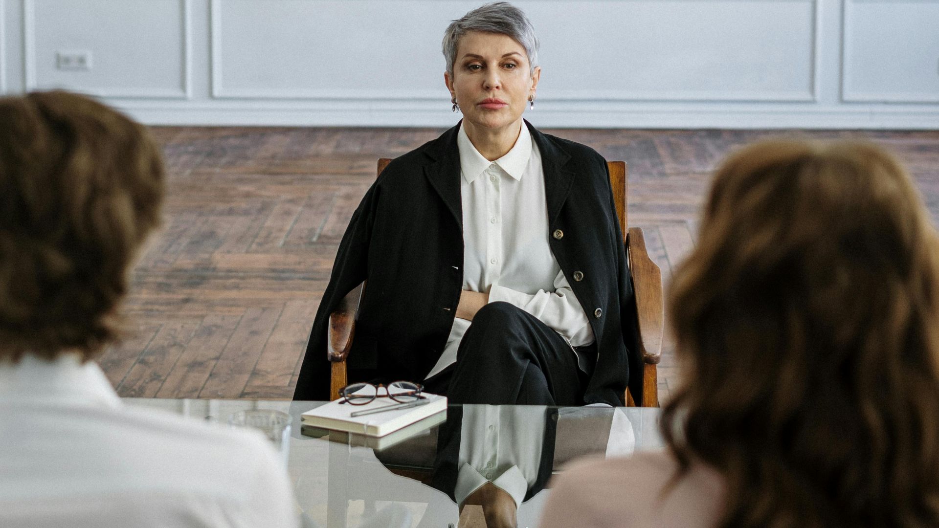 Couple receiving guidance from therapist in a stylish and serene office setting.