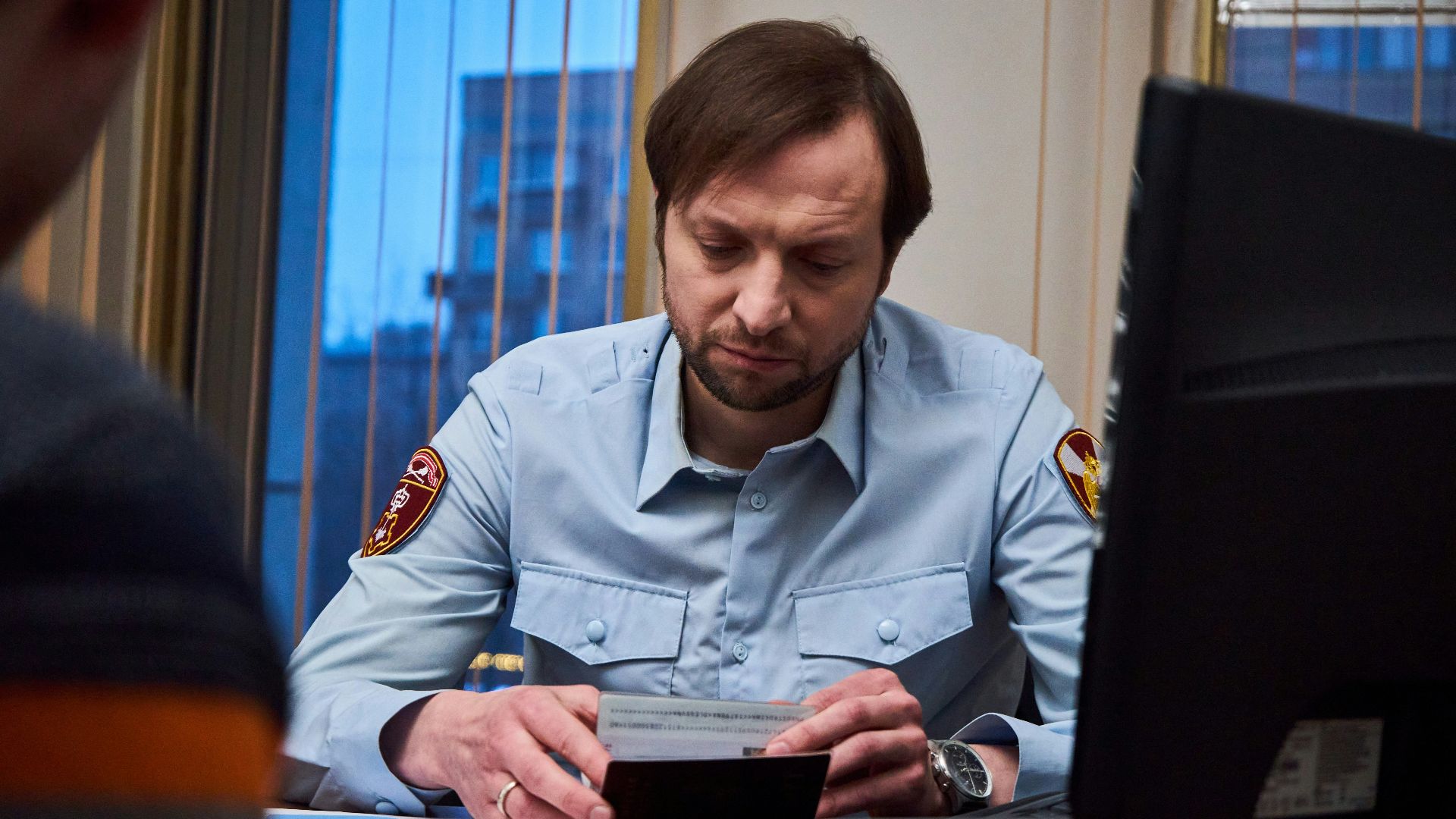 woman in blue button up shirt sitting at the table