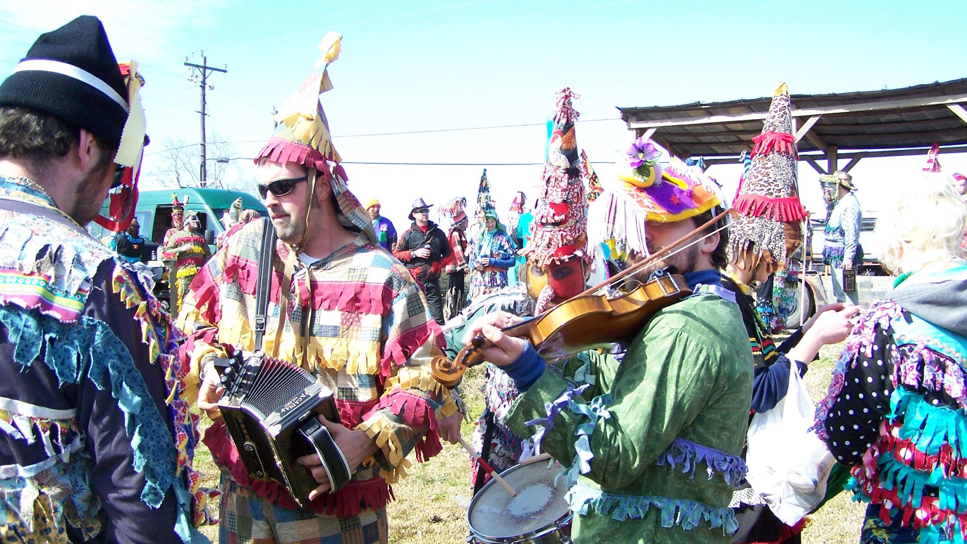 Wilson Savoy of the Pine Leaf Boys (cajun accordion player in sunglasses and patchwork costume) playing with other Cajun musicians at the 2010 Faquetigue Courir de Mardi Gras in en:Savoy, Louisiana.
