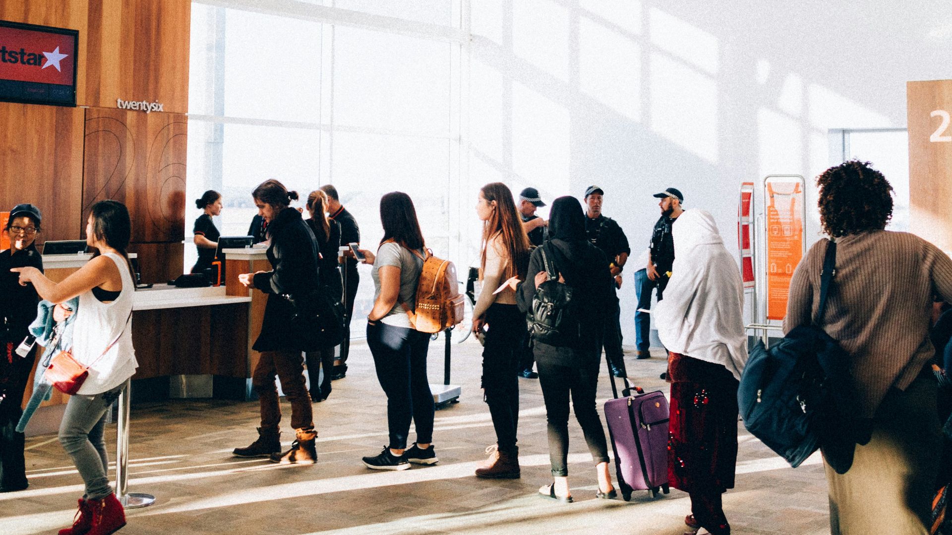 a group of people standing in a large room