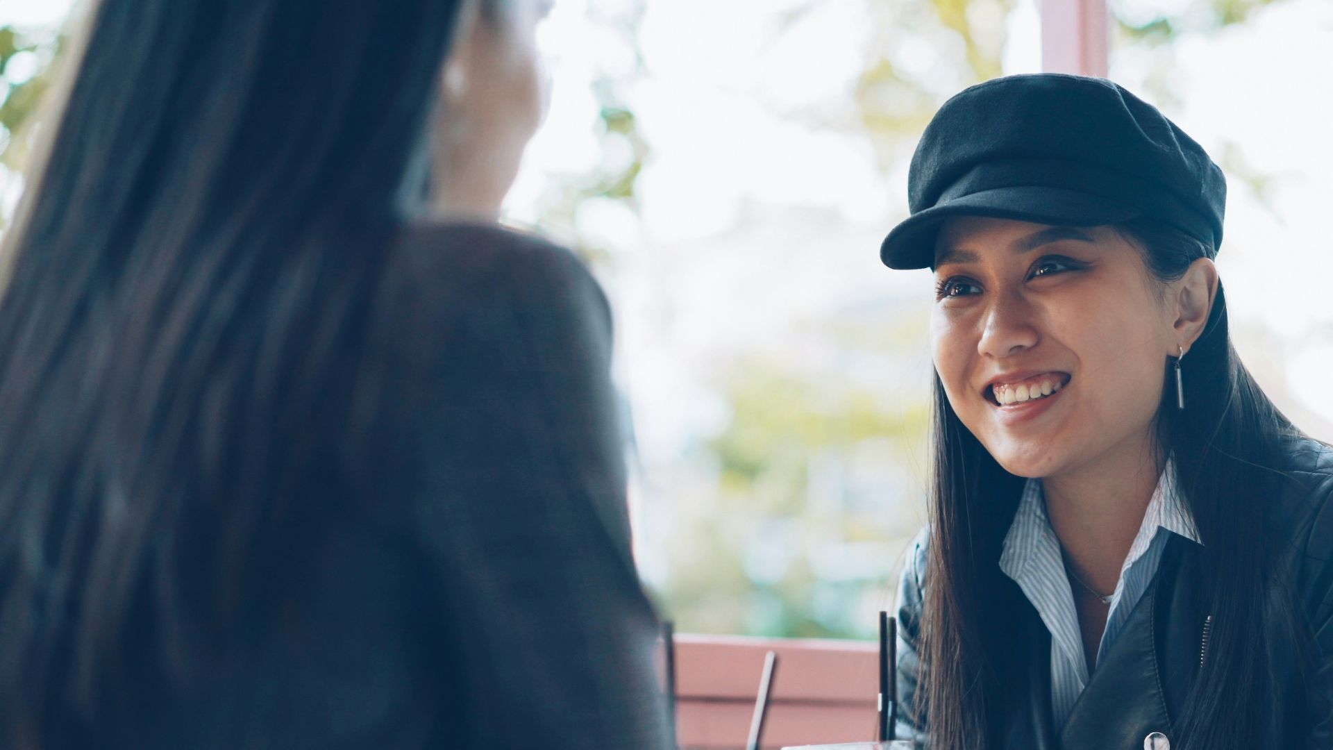 Two women talking at an outdoor cafe