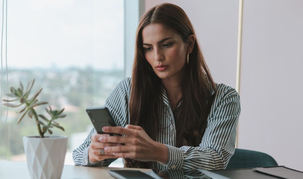 Portrait of Brown Haired Woman Using Phone in Office