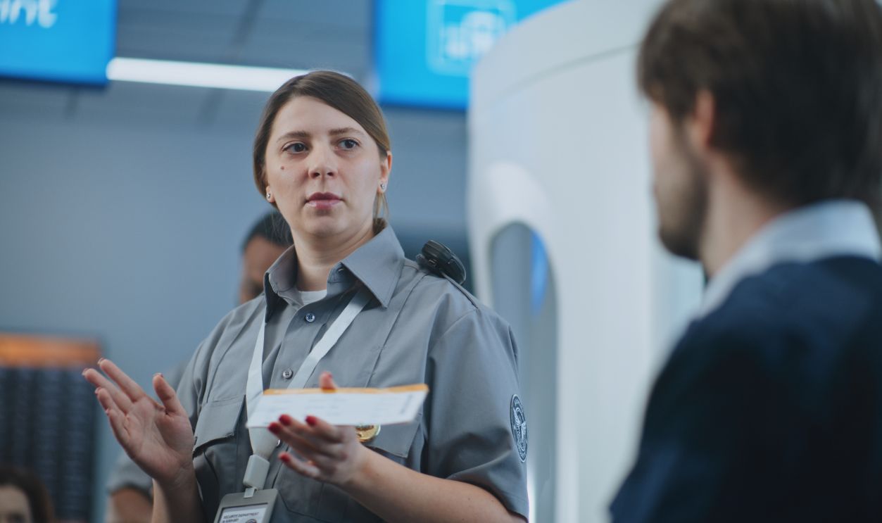 Shutterstock-2597007513, Airport Staff Briefing: Female TSA Officer Giving Instructions