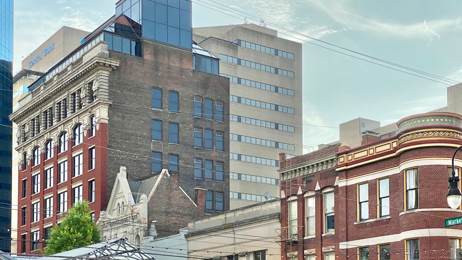 Built in the 19th Century and 20th Century, these buildings these buildings demonstrate the general architecturally diverse character of Downtown Lexington’s historic blocks, with a variety of styles represented.  Most of the buildings are contributing structures in the Lexington Downtown Commercial Historic District, listed on the National Register of Historic Places in 1983.
Pictured in the background, from left to right, are modern skyscrapers on the Lexington skyline, including the Lexington Financial Center, Kincaid Towers, Vine Center and Hilton Lexington/Downtown.