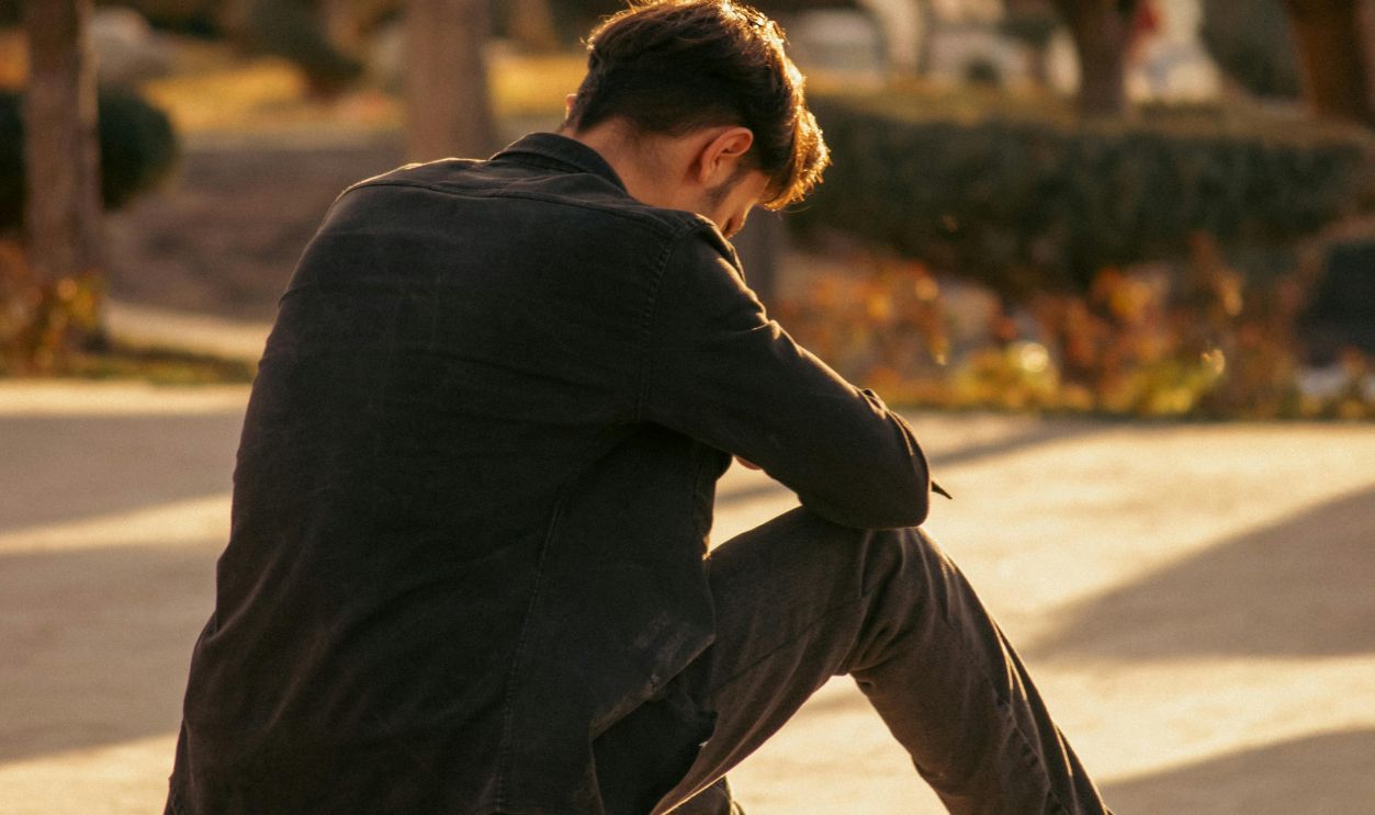 Contemplative Moment in Sunlit Urban Park