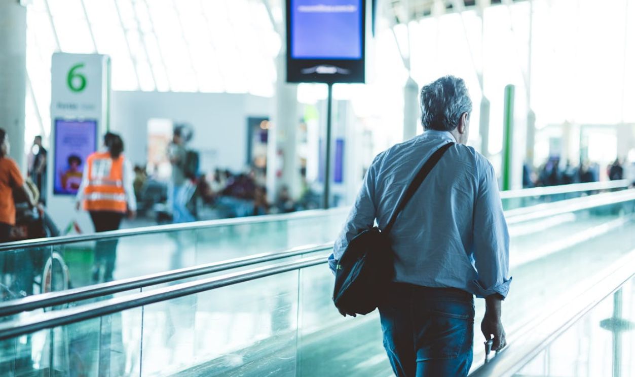 Man Walking in an Airport Terminal