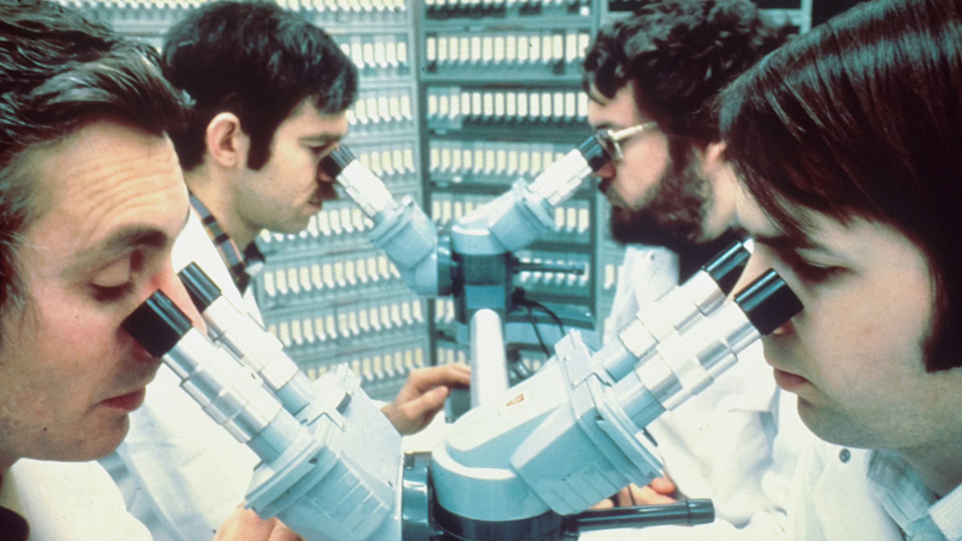 2 men in white and blue uniform holding blue and white plastic toy