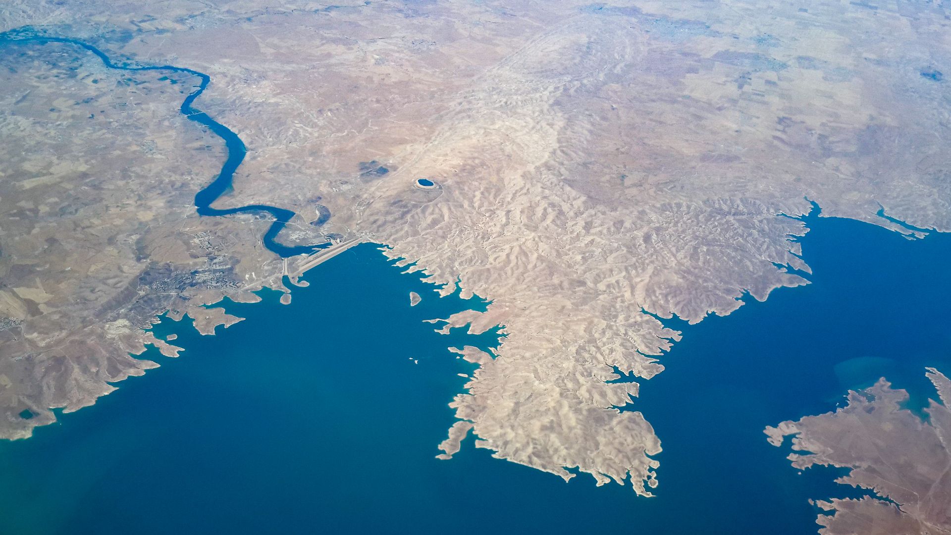 Aerial photo of Mosul dam, hydroelectric project and lake in Iraq.