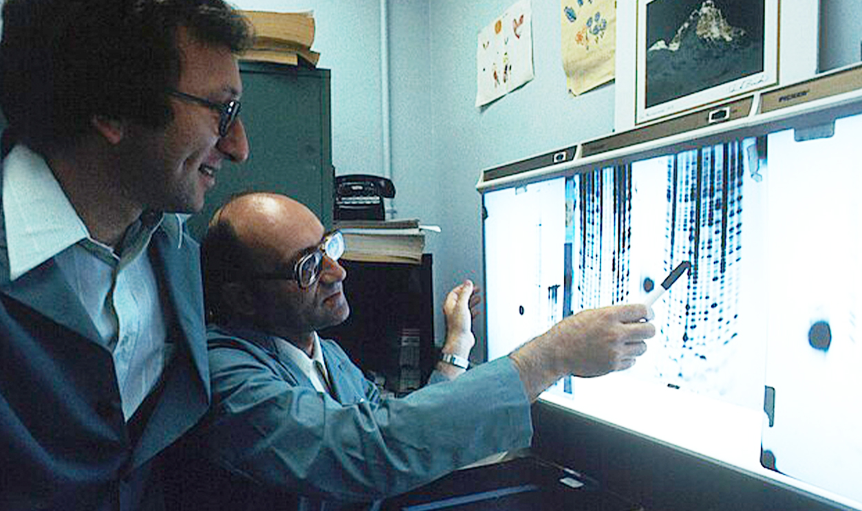 Two scientists looking at DNA sequencing