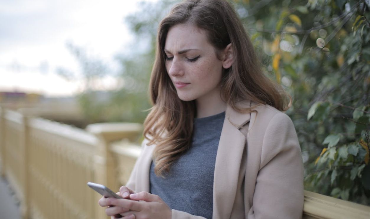 Pensive Woman in Using Smartphone