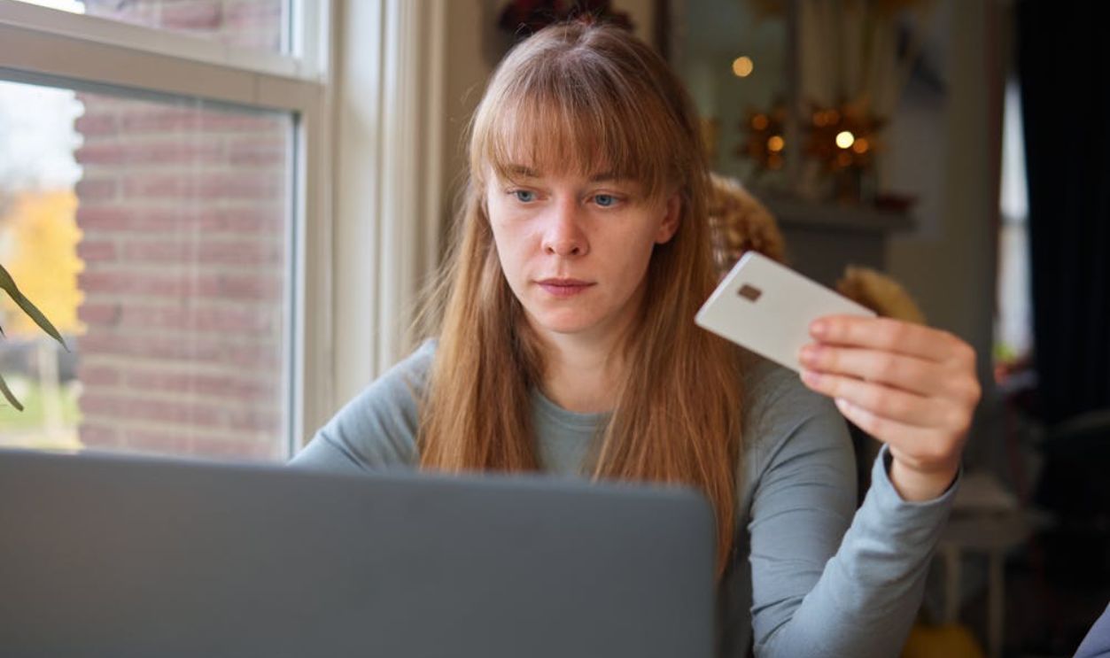 A Woman in Gray Long Sleeve Shirt Looking at the Laptop