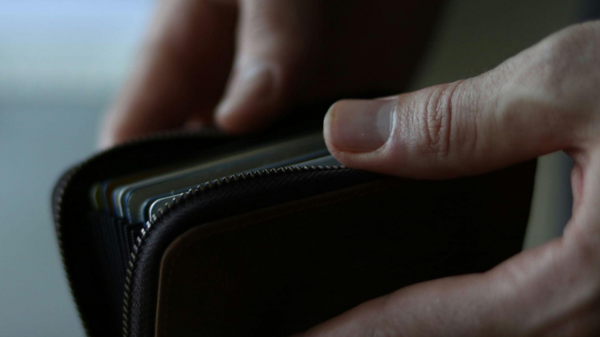 a person holding a wallet in their hand