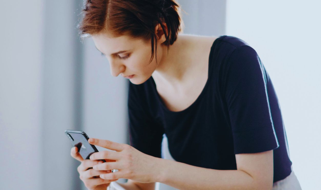 Woman Taking Photo of Coffee Pot