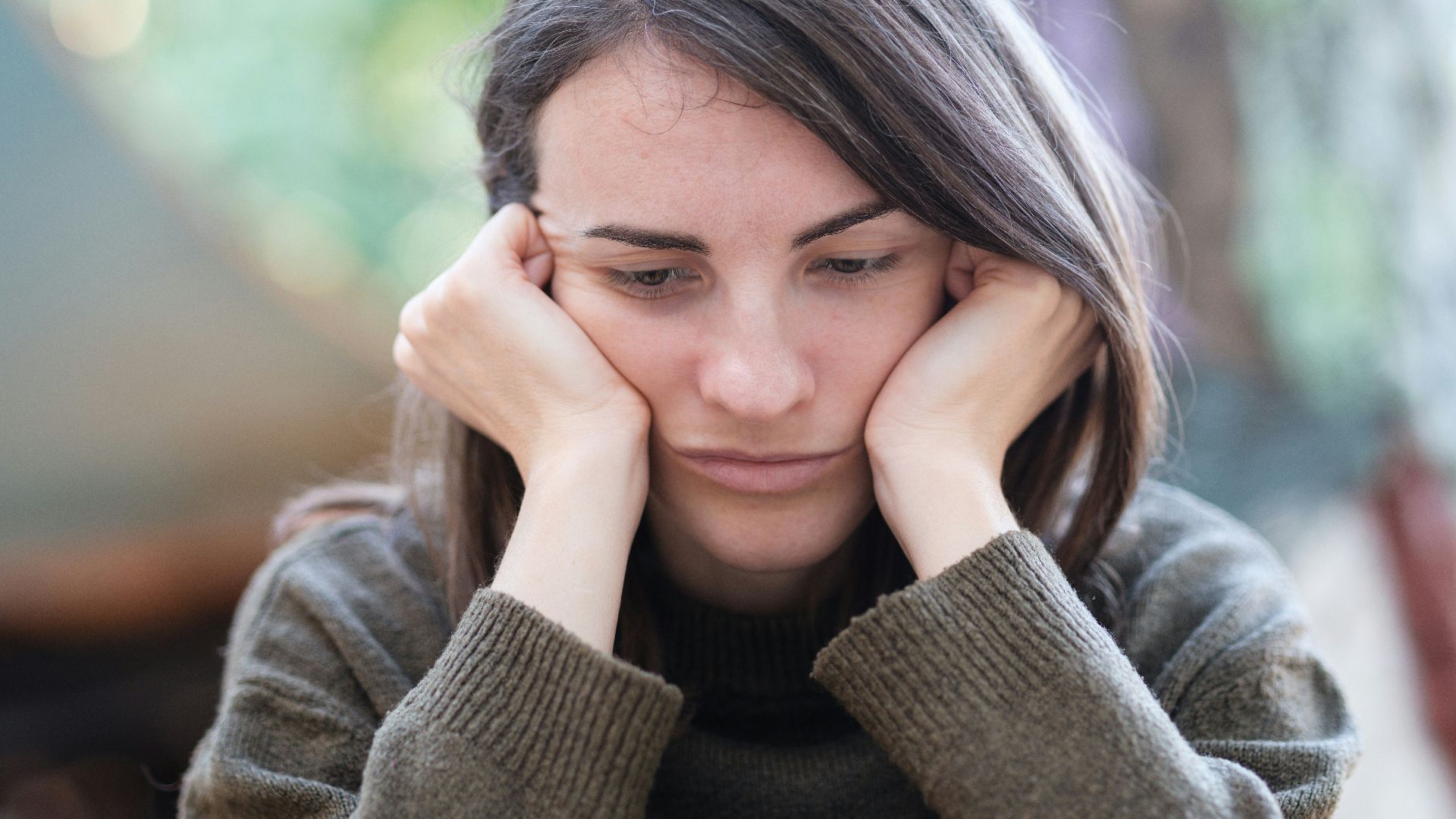 a woman holding her head in her hands