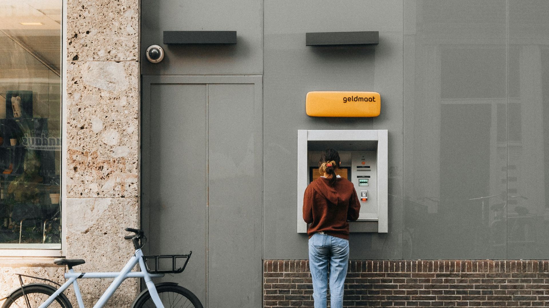 a person standing in front of a atm machine