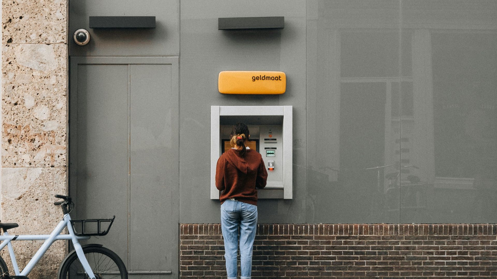 a person standing in front of a atm machine