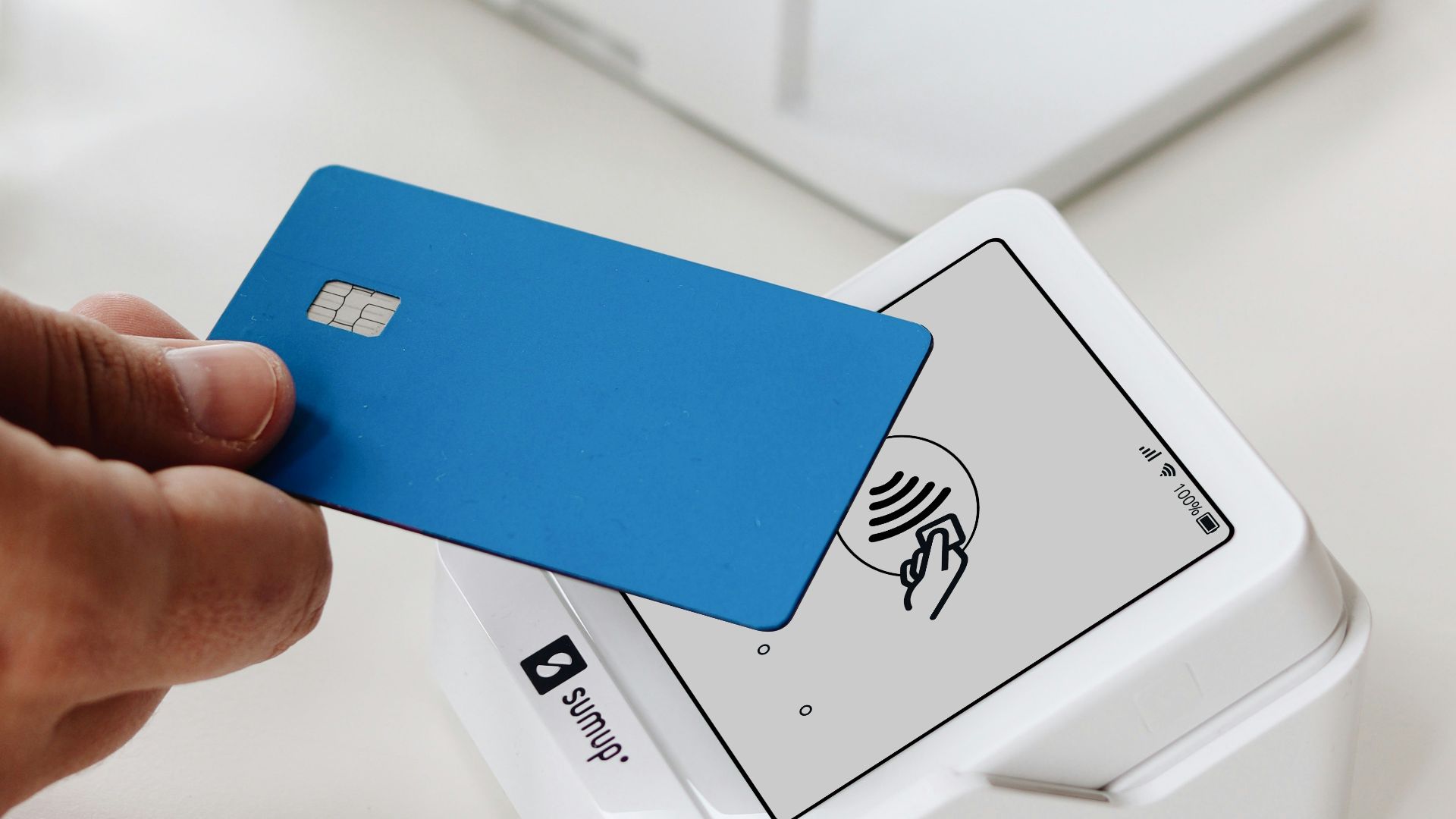 A person holding a credit card in their hand