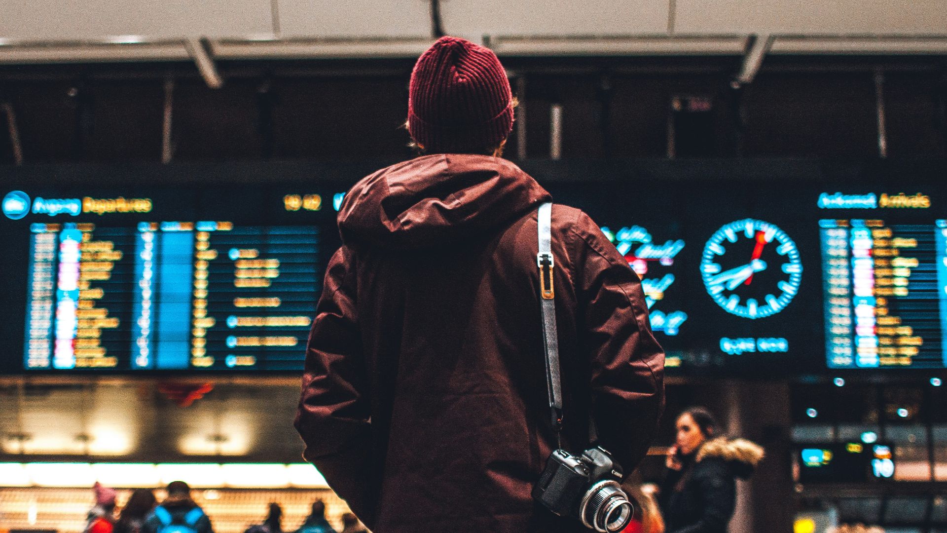 person looking up to the flight schedules