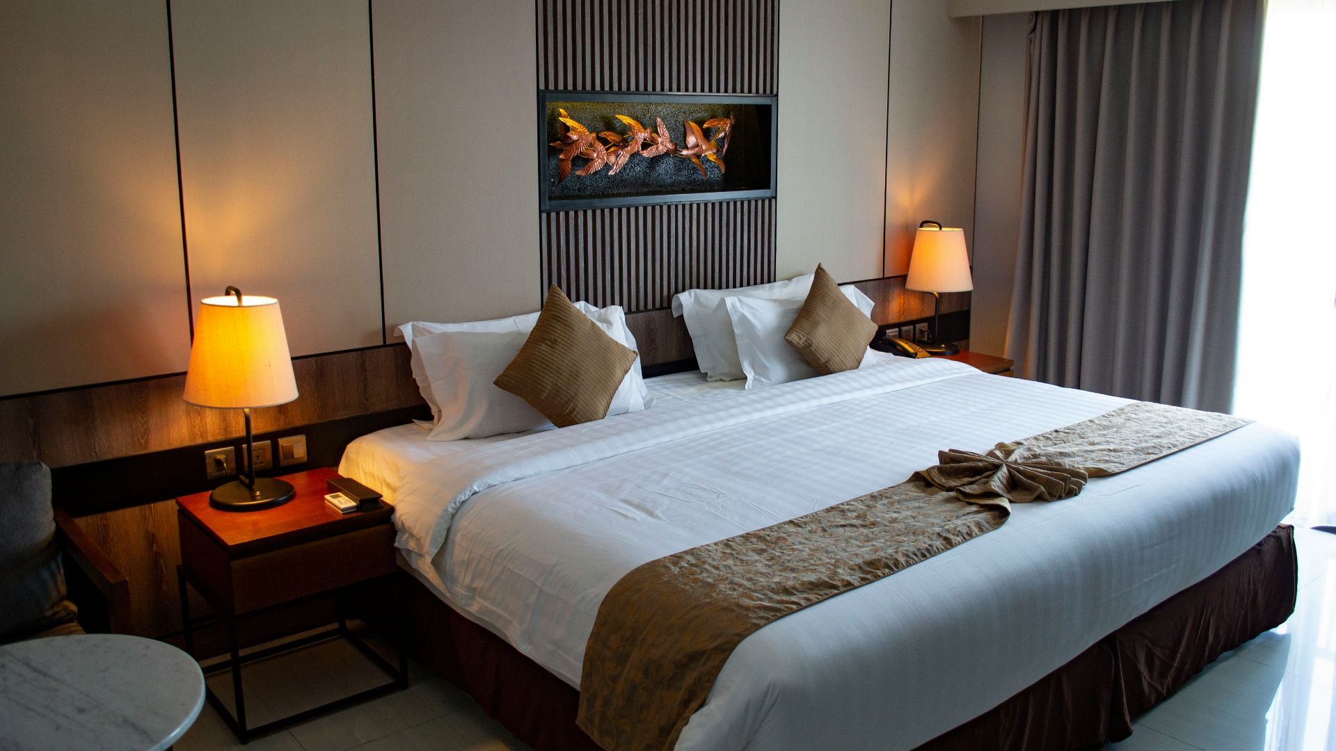 white bed linen with throw pillows