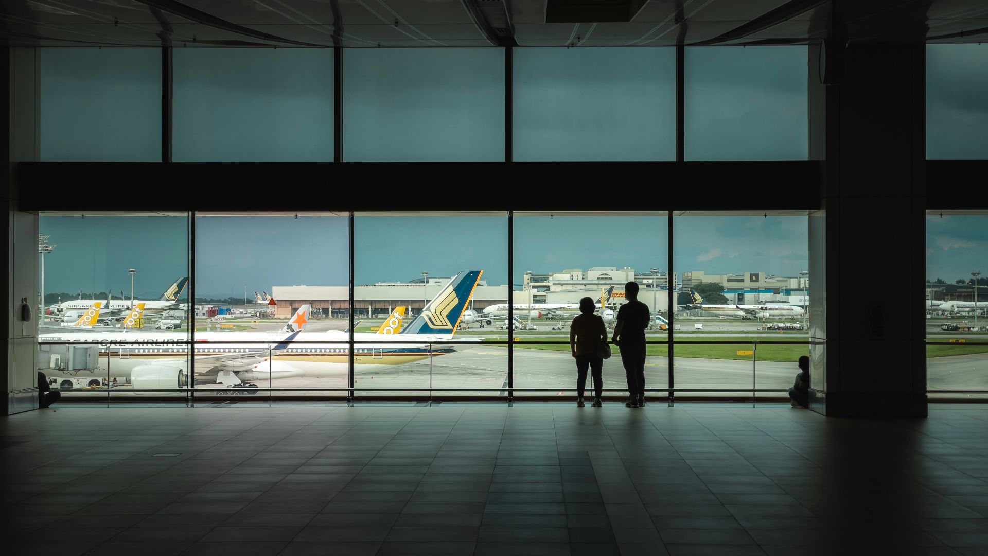 man in black jacket walking on sidewalk during daytime