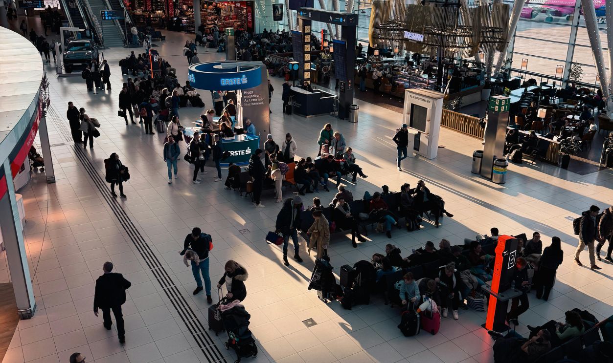 Busy Airport Terminal with Passengers Awaiting Flights