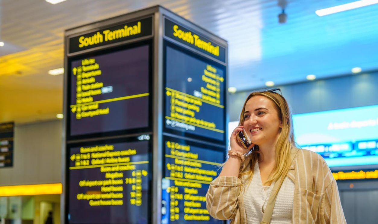 Woman Speaking on Phone at Gatwick Airport