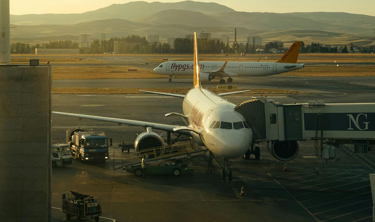 Commercial Airplane Parked at Airport Gate at Sunrise