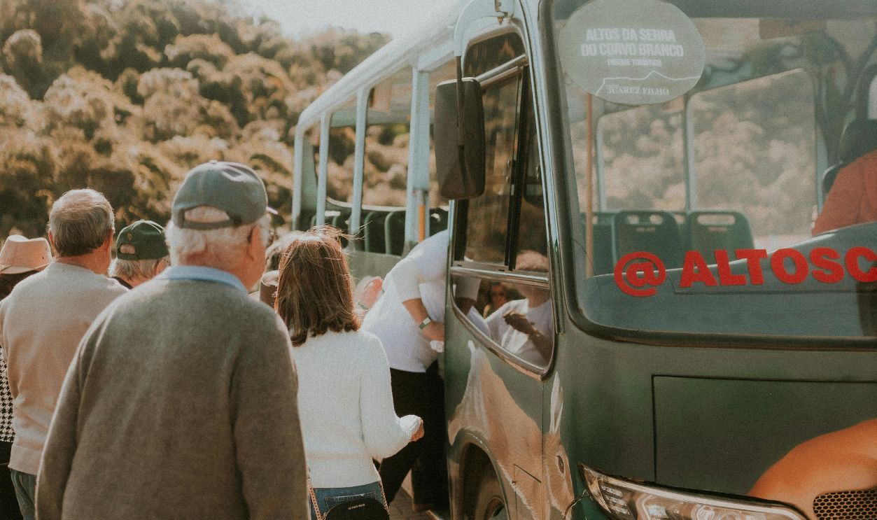 A group of people standing around a bus