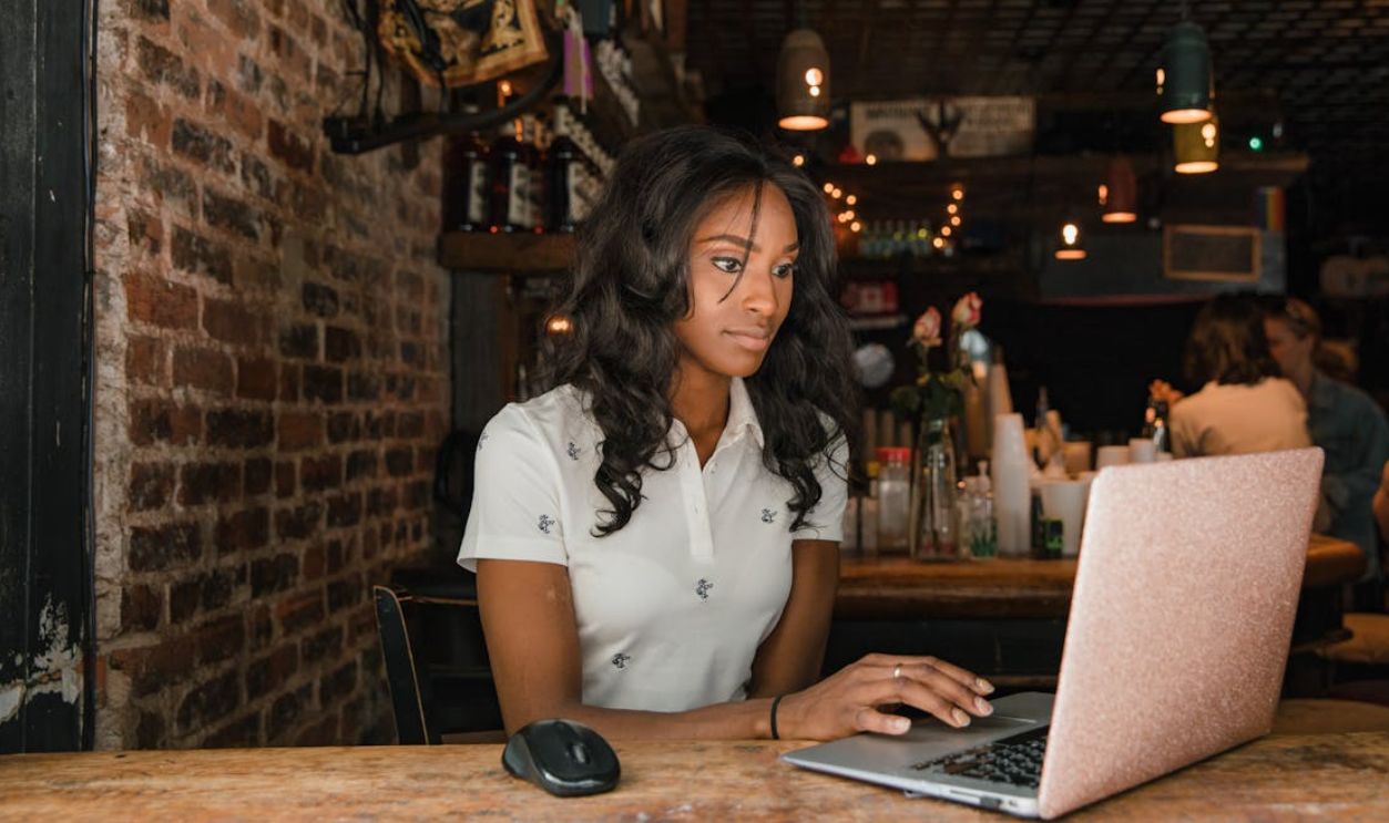 Woman Using Laptop at Cafe