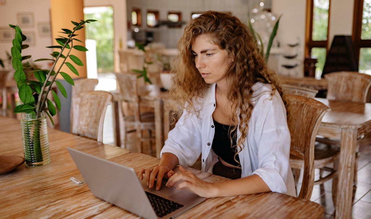 Young woman using laptop at vintage cafe