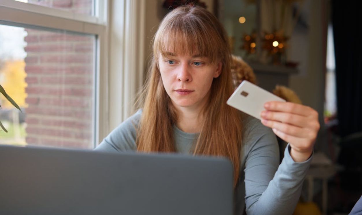A Woman in Gray Long Sleeve Shirt Looking at the Laptop