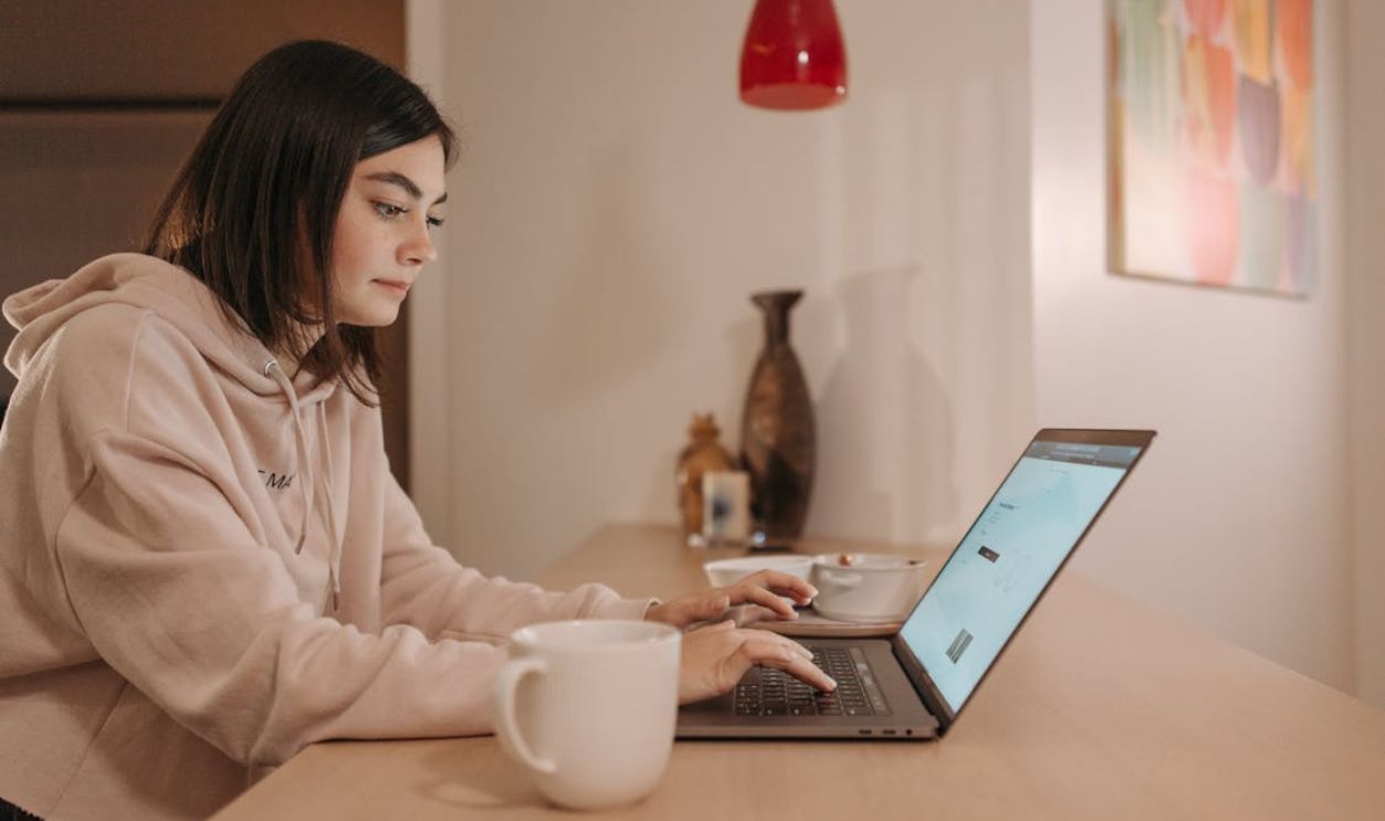 A Woman Using a Laptop while Working at Home