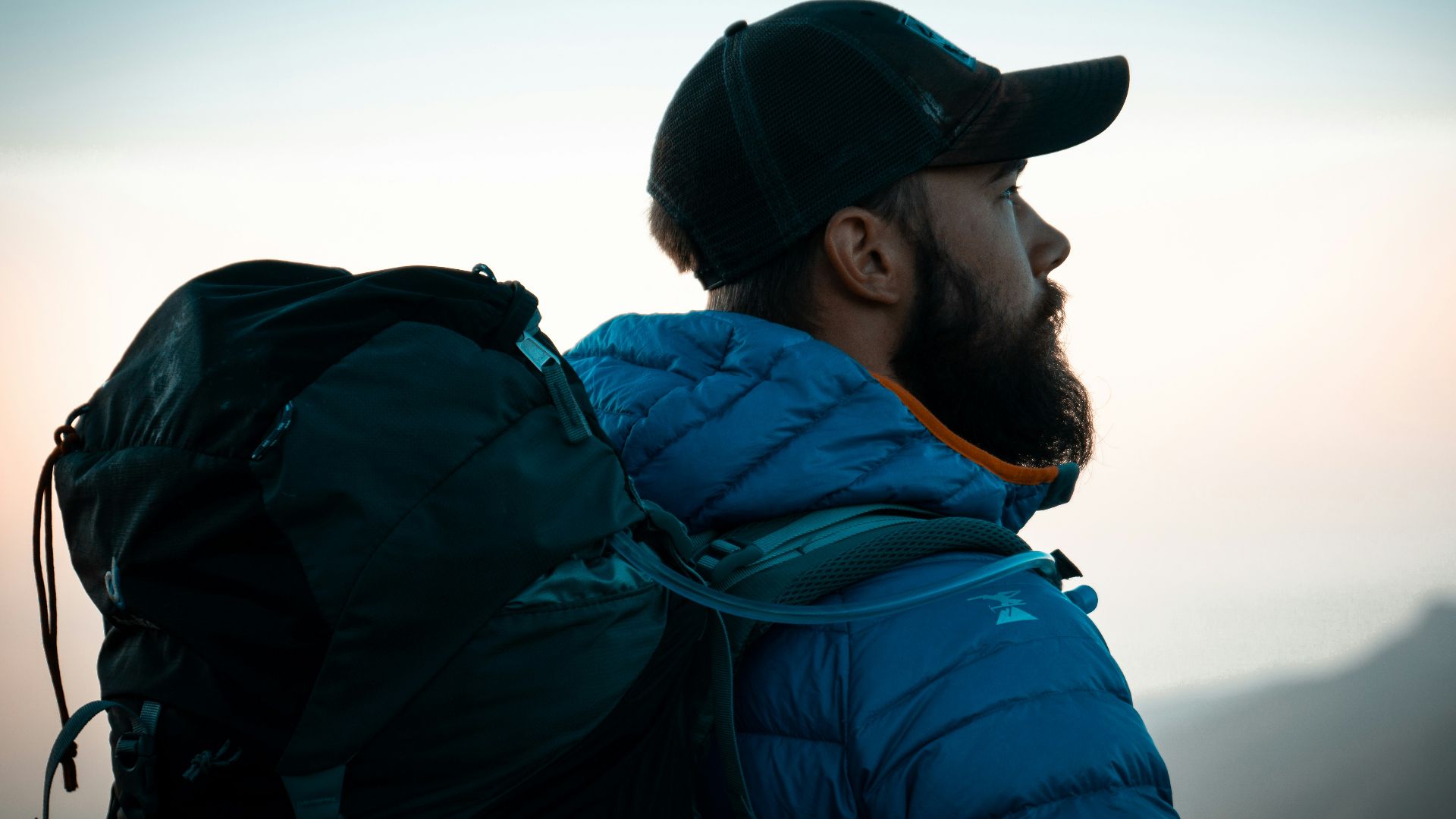 man in blue and black jacket and black cap